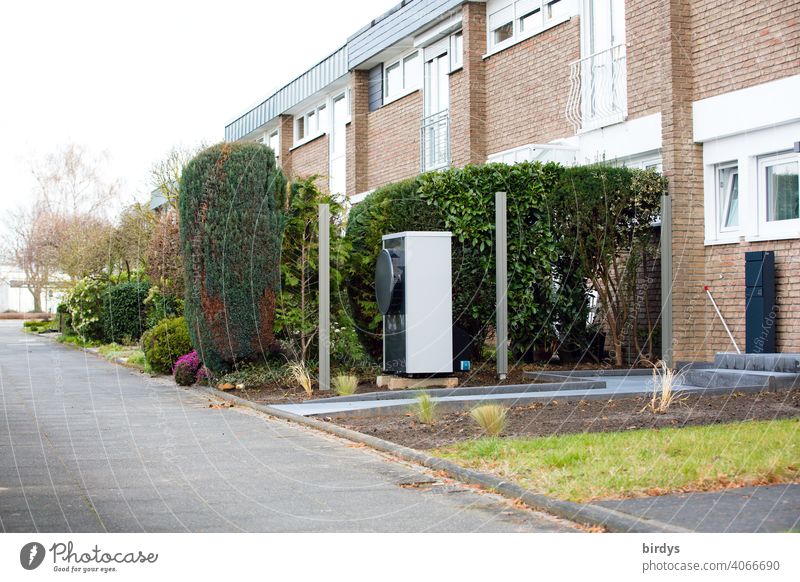 Air source heat pump in front of a terraced house. Modern, environmentally friendly heating technology, air source heat pump Heating Air-to-water heat pump