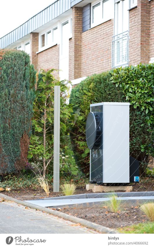 Air source heat pump in the front garden of a terraced house. Modern, environmentally friendly heating technology Heating Air-to-water heat pump sustainability