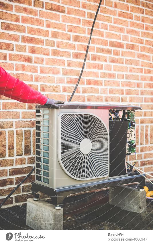 Installation of an air source heat pump by an installer Air source heat pump installation Installer Renewable energy Modern Innovative New building