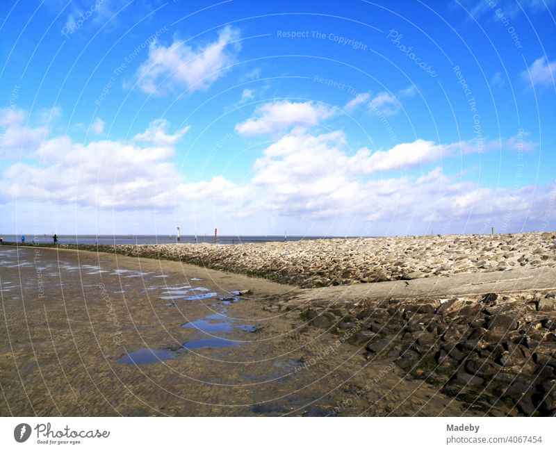 The mudflats at low tide at the harbour pier in Bensersiel in autumn at the coast of the North Sea near Esens in East Frisia in Lower Saxony Besensersiel