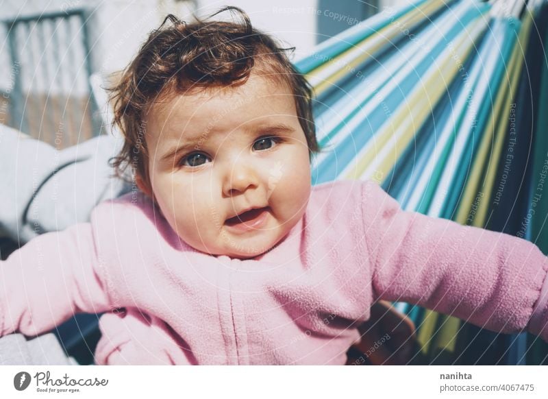 Little baby having fun on a hammock in a sunny day happy holidays lifestyle family babyhood child kid girl cute lovely time enjoy happiness leisure freedom