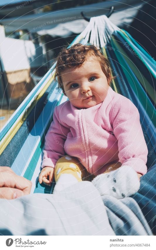 Little baby having fun on a hammock in a sunny day happy holidays lifestyle family babyhood child kid girl cute lovely time enjoy happiness leisure freedom