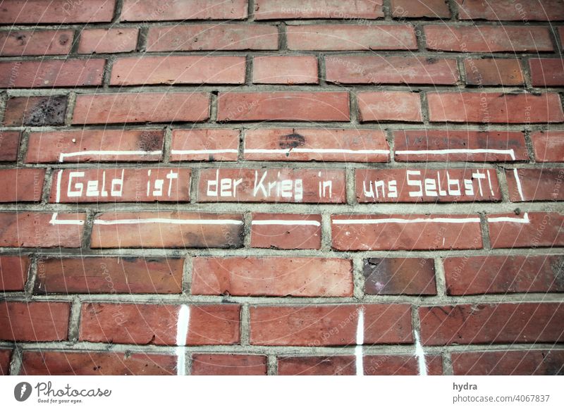 Criticism of capitalism on brick: money is the war within ourselves Money Capitalism Selfishness Socialism Antisocial Philosophy Ethics posture War Setting