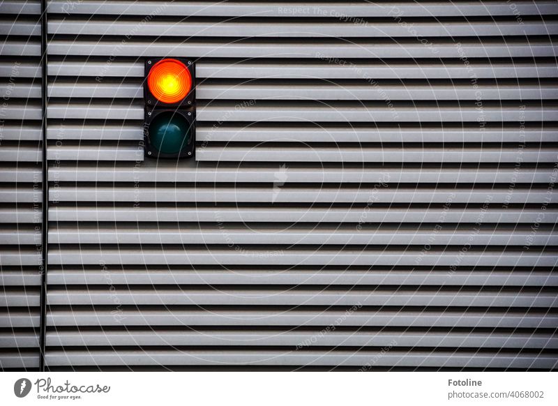 Red! says the traffic light at the garage door. Traffic light Light Lamp Stripe Garage Goal Tin Metal Exterior shot Garage door Colour photo Deserted