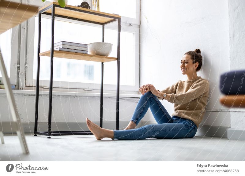 Portrait of a smiling creative woman in a modern loft space millennials student hipster indoors window natural girl adult one attractive successful people