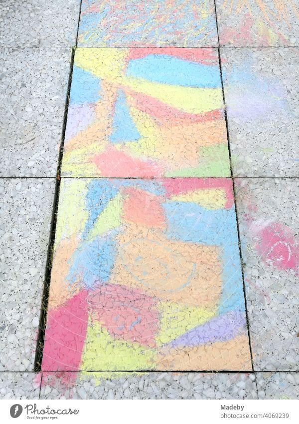 Stone slabs painted by a child with colourful chalk on a balcony in Oerlinghausen near Bielefeld on the Hermannsweg in the Teutoburg Forest in East Westphalia-Lippe.