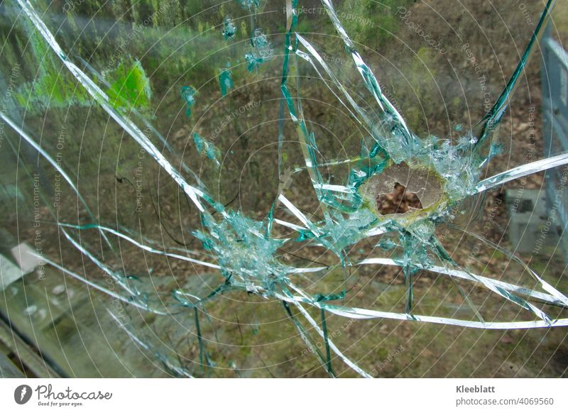 Broken bulletproof glass pane of a pedestrian bridge - detail photo Smashed window Hollow Splinter Glass Destruction Colour photo Exterior shot Shard