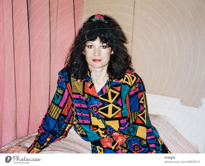 A young woman sits on a bed and looks into the camera Woman Young woman variegated Blouse Dark-haired Drape Photography Analog analogue photography Paper Curl