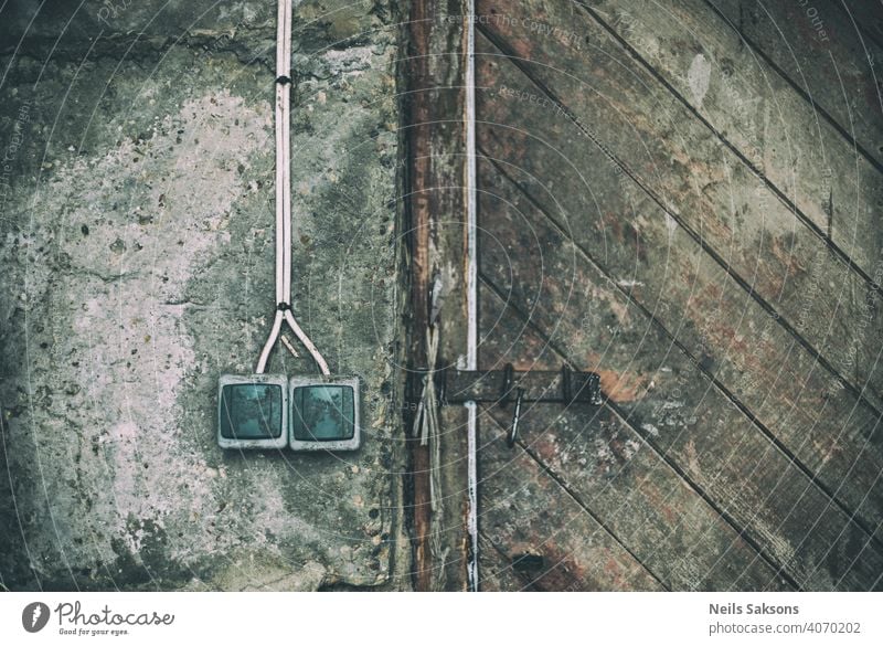 old sockets on concrete wall and wooden vintage door Abstract apartment architecture background business cobweb concept construction decay dirty electric