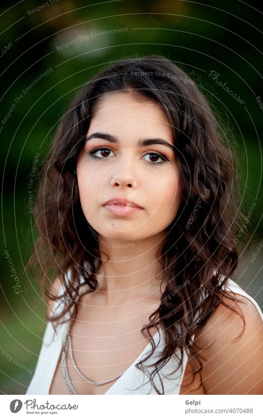 Beautiful brunette girl relaxing in the park portrait outside teenager pretty female young happy beauty cute nature woman green person attractive smile