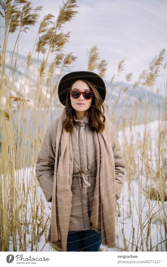 young girl in the hat girlfriend Ear River bank Siberia Sunglasses Hat Scarf Reflection Russian Yenisey youth standing meditative cold alone beautiful lifestyle