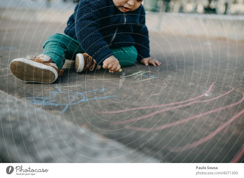 Child drawing with colored chalk on the floor Caucasian 1 - 3 years Authentic Chalk Chalk drawing Infancy Playing Colour photo Street painting Art