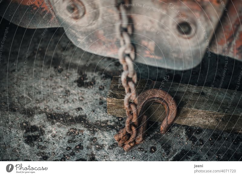 Hook on the winch of a crane on an abandoned port facility Checkmark Hook-shaped cable winch Rope Train steel cable Rotate Pull Tall Harbour Port area