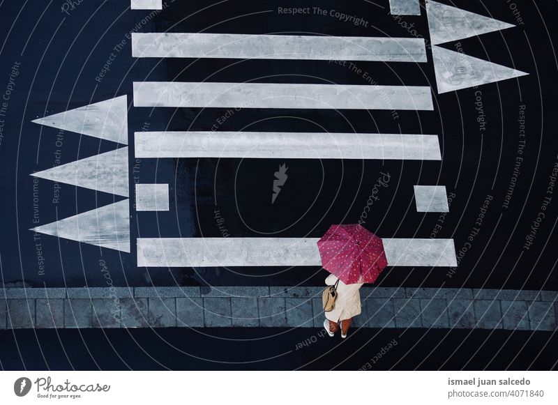 woman with an umbrella on the crosswalk people person rain rainy raining day rainy day water human pedestrian street city urban bilbao spain walking lifestyle