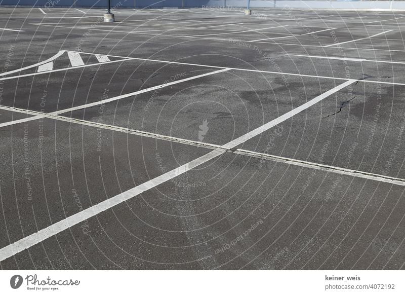 Empty parking space in a parking lot with road markings Parking lot Search for a parking space nobody Deserted Car-free Sunday corona shutdown lockdown Closed