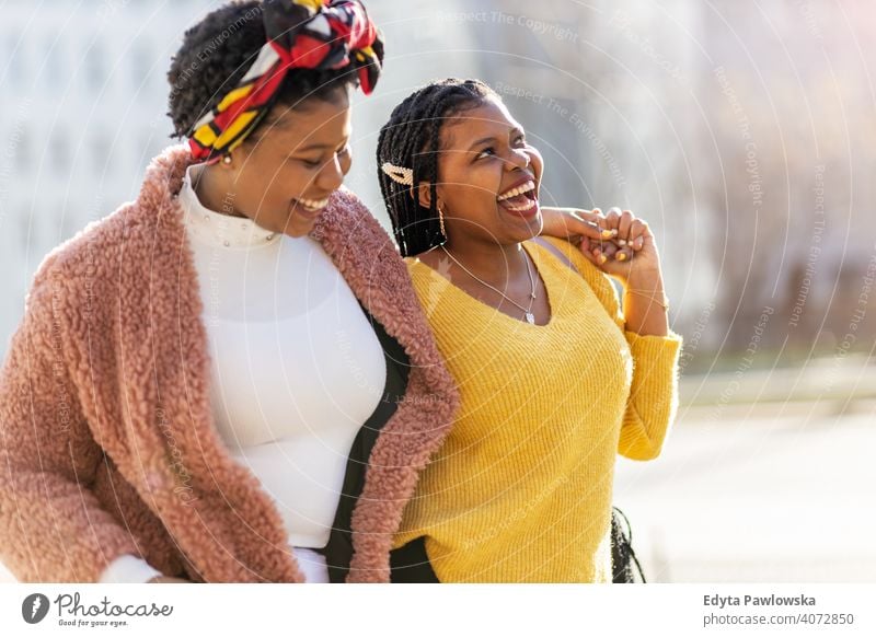 Beautiful happy girlfriends talking and smiling in city diversity diverse people love outdoors day positivity confident carefree woman young adult casual