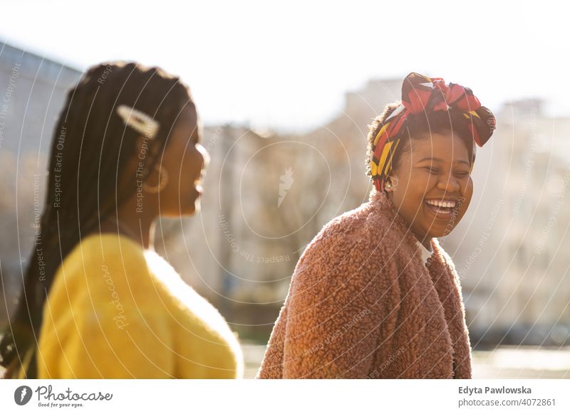 Beautiful happy girlfriends talking and smiling in city diversity diverse people love outdoors day positivity confident carefree woman young adult casual