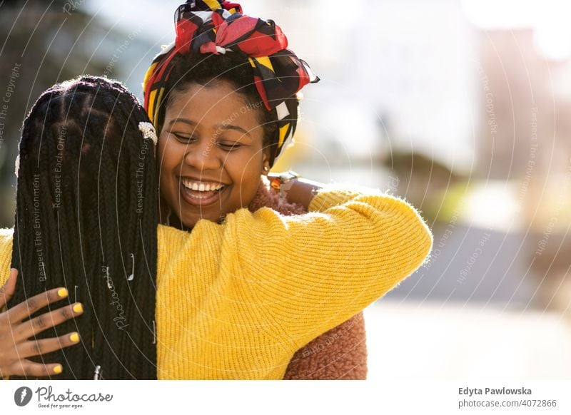 Portrait of two beautiful happy girlfriends embracing outdoors diversity diverse people love day positivity confident carefree woman young adult casual