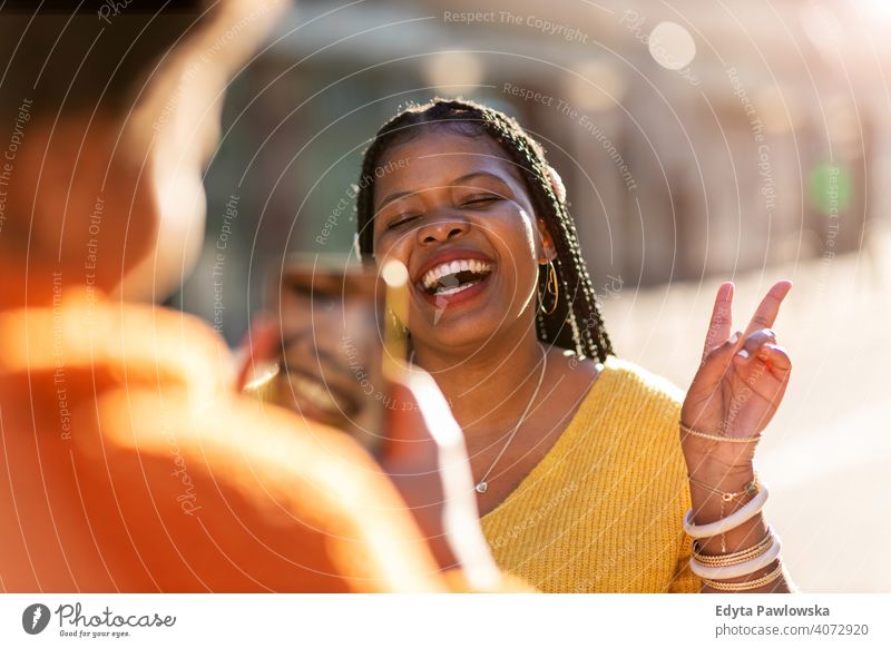 Beautiful happy girlfriends taking a selfie together African afro diversity diverse people love outdoors day positivity confident carefree woman adult casual