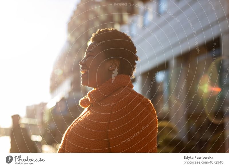 Afro american woman in an urban city area one person alone outdoors day positivity confident carefree people young adult casual beautiful attractive female