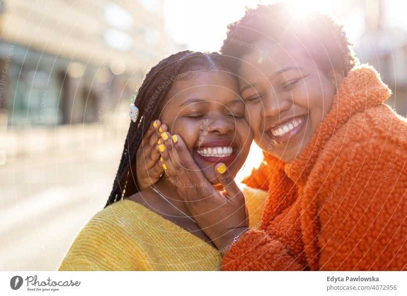 Two beautiful Afro american women having fun together in the city diversity diverse people love outdoors day positivity confident carefree woman young adult