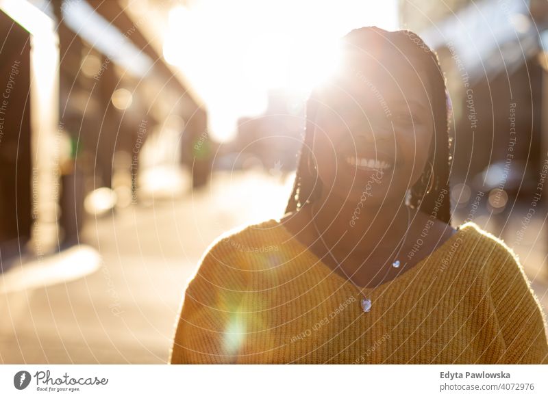 Afro american woman in an urban city area one person alone outdoors day positivity confident carefree people young adult casual beautiful attractive female