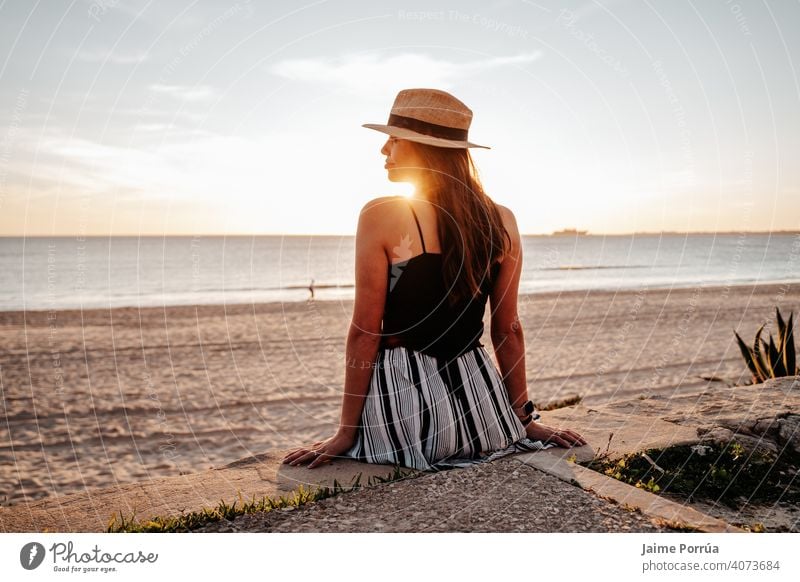 Young woman with hat on the beach on vacation in southern spain nature summer ocean sea sky sunny young happiness natural wireless leisure activity portrait