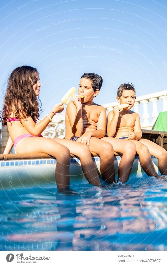 Three funny kids eating an ice lolly boy brother caucasian cheerful child childhood children cream daughter day dungaree enjoy exterior family food fresh frozen