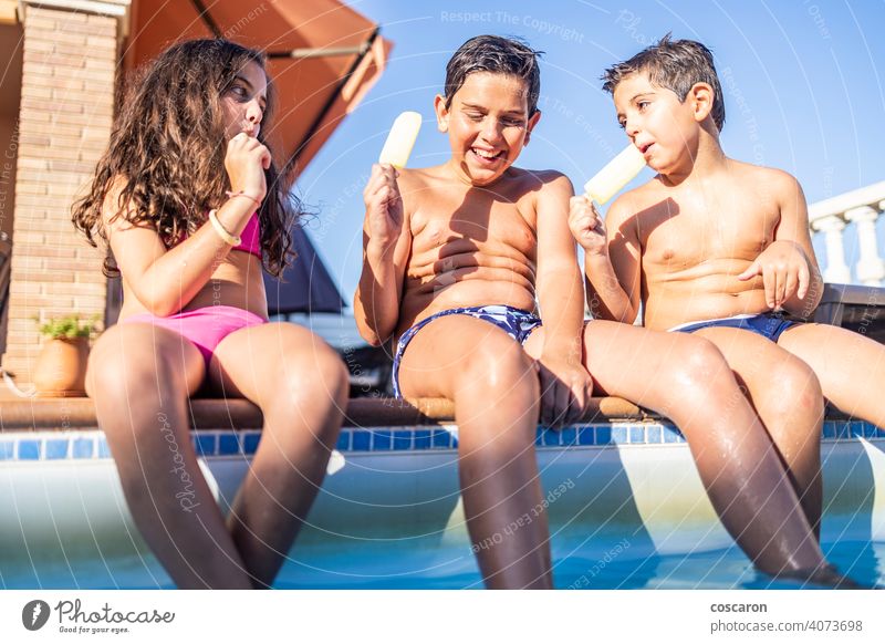 Three funny kids eating an ice lolly boy brother caucasian cheerful child childhood children cream daughter day dungaree enjoy exterior family food fresh frozen