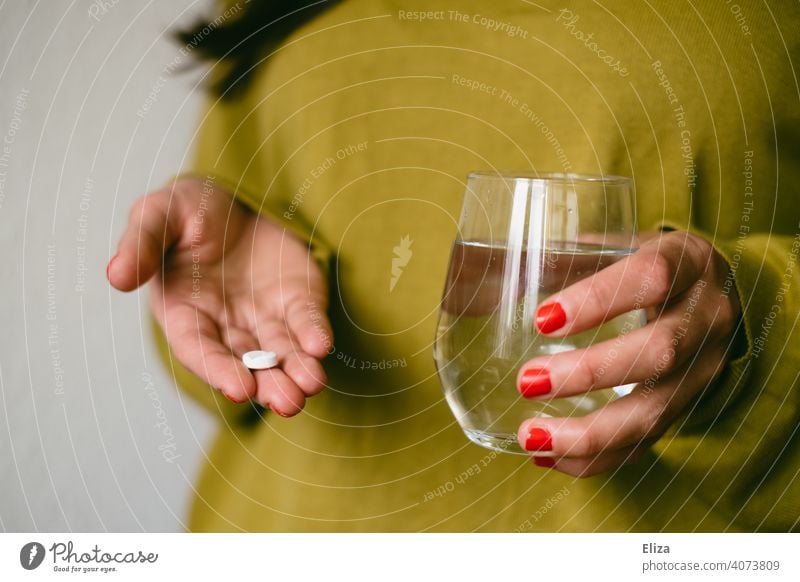 A woman holds a tablet and a glass of water in her hands. Taking medicine. Pill Medication headache tablet Ibuprofen Water Tumbler Healthy Illness Painkiller