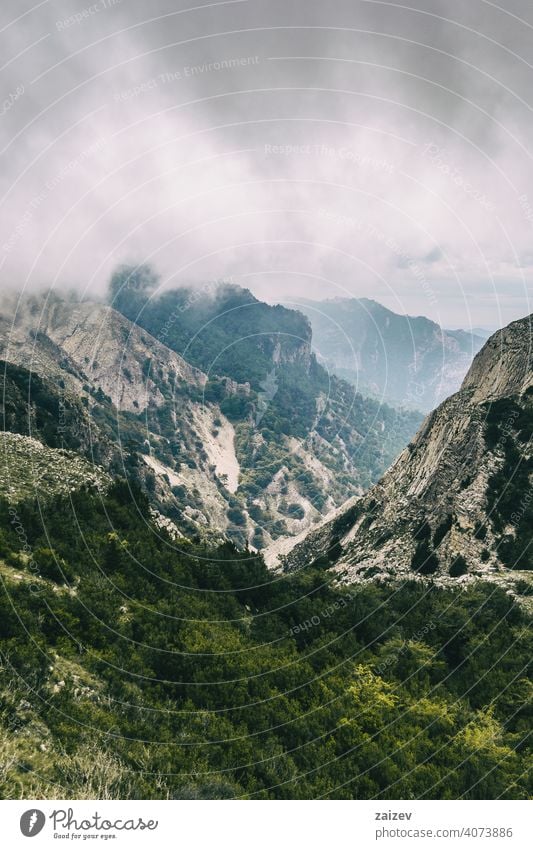 cloudy day with fog in the mountains of the natural park of the ports, in tarragona (spain) eroded layered canyon nature outdoors travel destinations descent