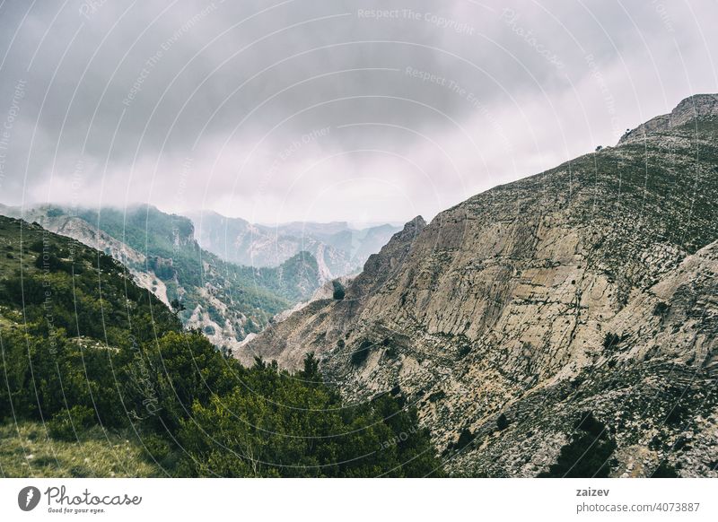 cloudy day with fog in the mountains of the natural park of the ports, in tarragona (spain) eroded layered canyon nature outdoors travel destinations descent