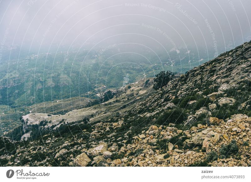 cloudy day with fog in the mountains of the natural park of the ports, in tarragona (spain) eroded layered canyon nature outdoors travel destinations descent