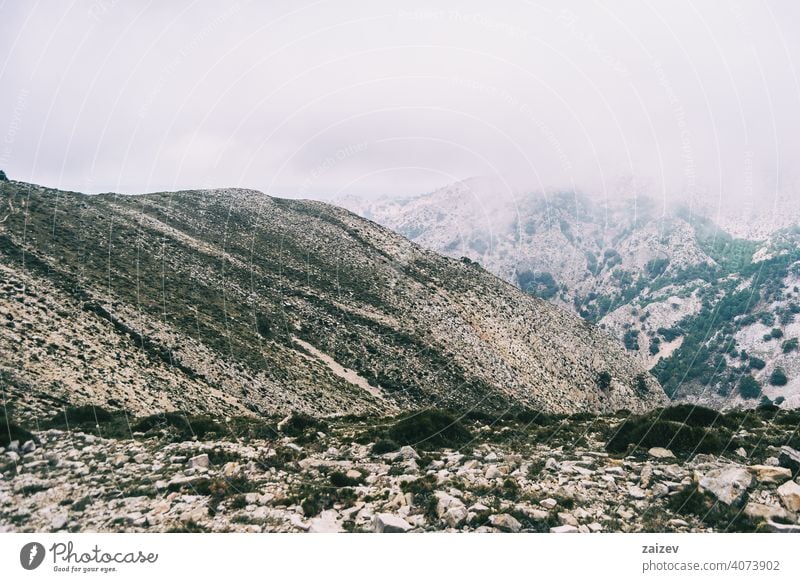 cloudy day with fog in the mountains of the natural park of the ports, in tarragona (spain) eroded layered canyon nature outdoors travel destinations descent