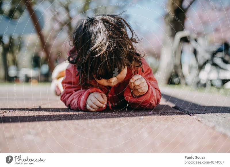 Cute girl laying down on the floor and watching insect Child childhood Caucasian 1 - 3 years Playing Curiosity Leisure and hobbies Childhood memory Infancy