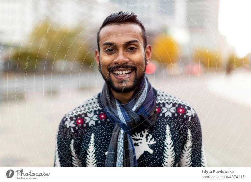 Portrait of a beautiful smiling man Indian ethnicity looking at the camera Sinhalese asian bearded outside street urban standing outdoors Warsaw one casual