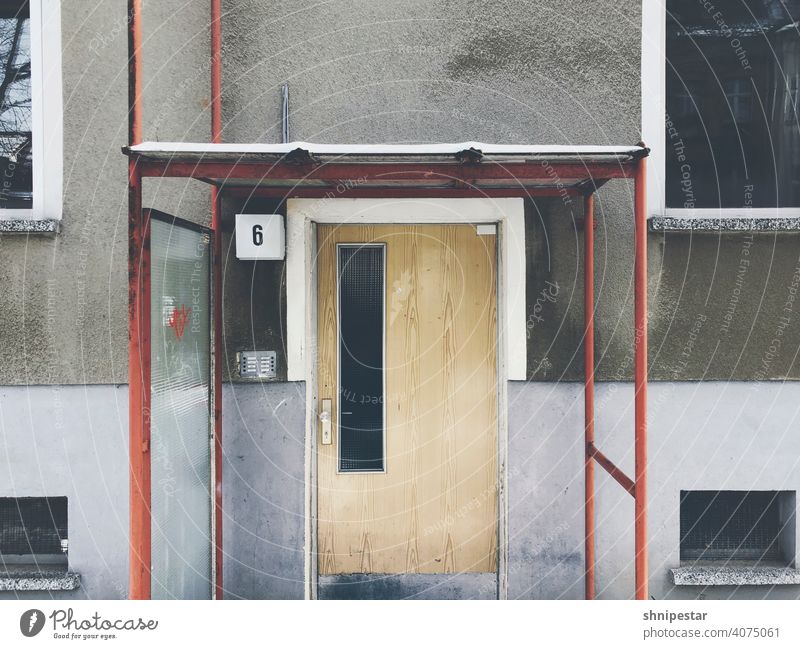 Exterior view of an entrance door from GDR times Apartment Building Entrance Front door Berlin Niederschönhausen number 6 House number Old Prefab construction