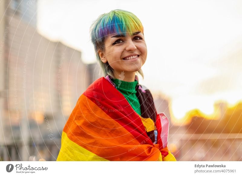 Portrait of a gender fluid person wearing rainbow flag non-binary gender fluidity lgbt equality homosexual lesbian pride gay parade man make-up identity