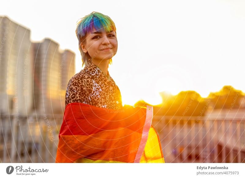 Portrait of a gender fluid person wearing rainbow flag non-binary gender fluidity lgbt equality homosexual lesbian pride gay parade man make-up identity