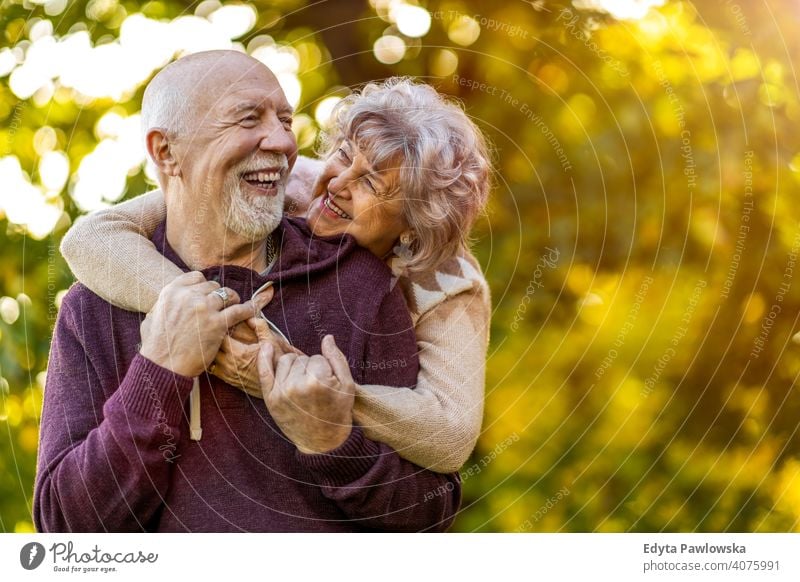 Happy senior couple enjoying a day outdoors in autumn love real people retired pensioner retirement aged grandmother grandparent grandfather two togetherness