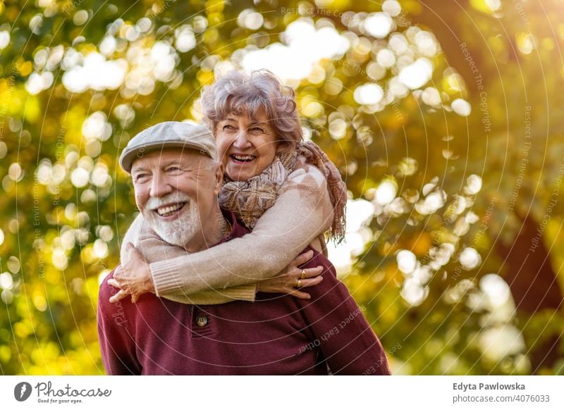 Happy senior couple enjoying a day outdoors in autumn love real people retired pensioner retirement aged grandmother grandparent grandfather two togetherness