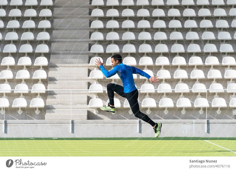 Black man jumping on a track. athletes friends training young fit fitness male athletic lifestyle healthy sport person muscular attractive workout body handsome