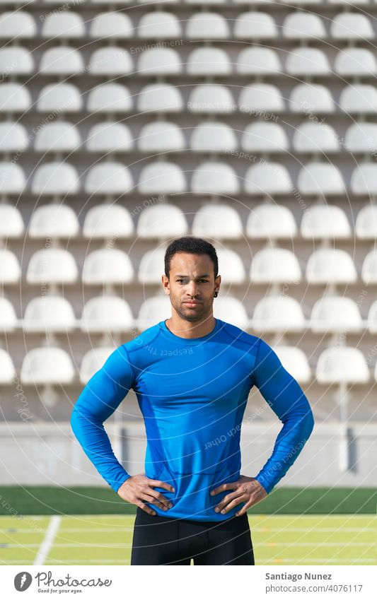 Portrait of Athlete on Running Track athlete runner african american looking at camera running track lifestyle akimbo arms 25 to 30 years old active black man