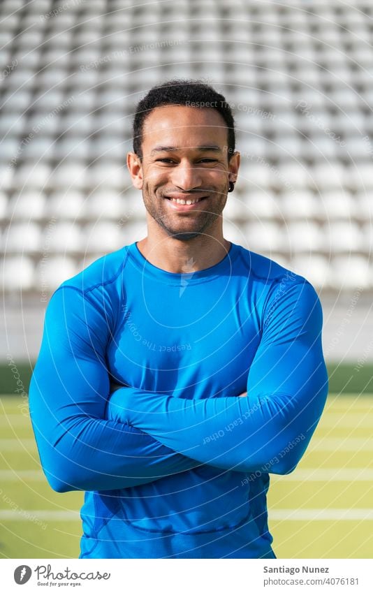 Portrait of Athlete on Running Track athlete runner african american looking at camera running track lifestyle akimbo arms 25 to 30 years old active black man