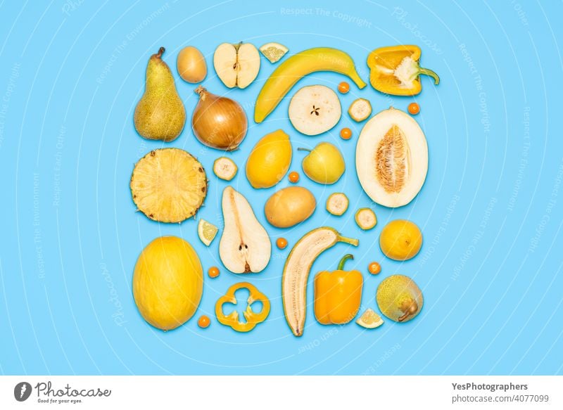 Yellow fruits and vegetables top view on blue background. above view apple banana citrus colorful colors copy space creative cut out detox diet diversity