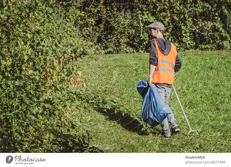 A man searches for trash in nature on World Cleanup Day clean up Action day social action Environment Trash September civic movement Eliminate removal