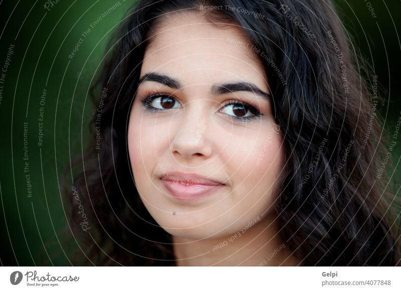 Beautiful brunette girl relaxing in the park portrait outside teenager pretty female young happy beauty cute nature woman green person attractive smile