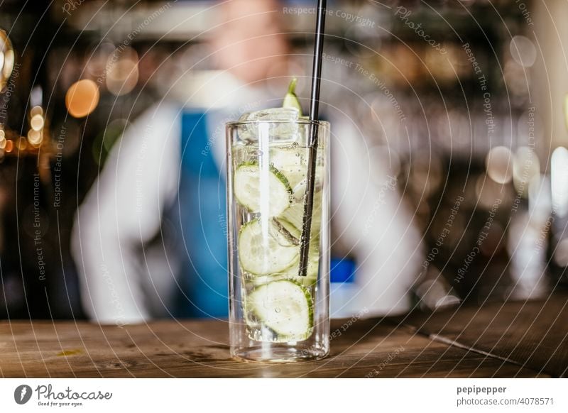 Cocktail with bartender in the background Cocktail bar Cocktail glass Cucumber lemon Glass Beverage Longdrink Bar Alcoholic drinks Spirits Cold drink Night life