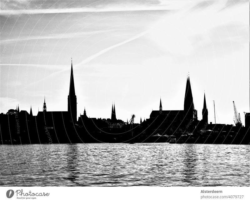 Skyline of Lübeck view from the north to the old town with the seven church towers in black and white city Lübeck view from north View old town Harbour