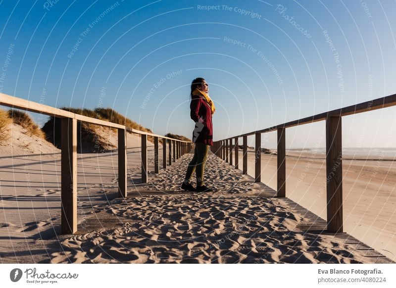 young caucasian woman with eyes closed relaxing at the beach at sunset. Holidays and relaxation concept vacation holidays runway passage attractive pretty